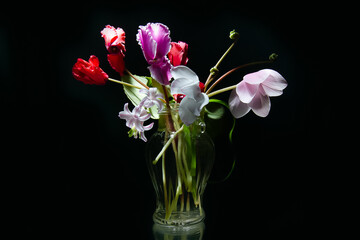 А bouquet of flowers in a vase on a rough background! Delicate spring flowers.