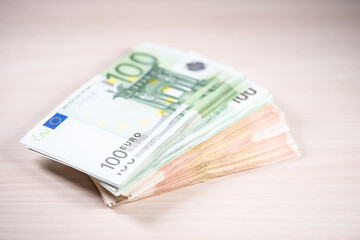 Bunch of euro banknotes on the wooden table