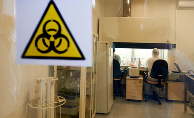 Laboratory. Coronavirus. Doctors and doctors in protective suits and masks that cover the face.