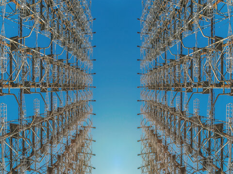 Giant electric antenna against the blue sky and the rising sun