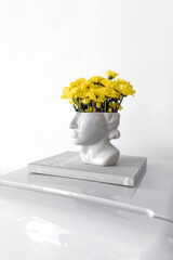 Head with yellow flowers sculpture