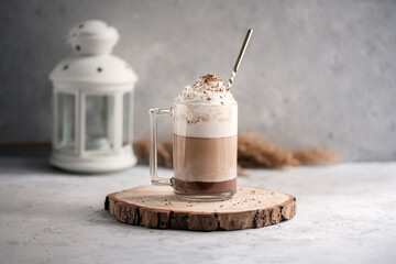 Coffee cocktail mocha with whipped cream on a wooden tray on a stone gray background. Delicious...