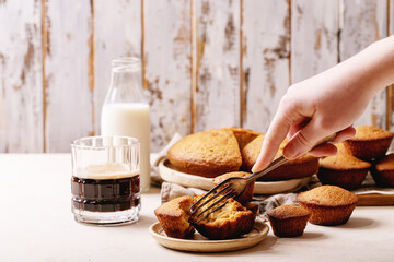 Female hand holding homemade muffins