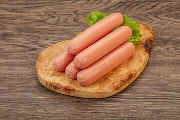 Tasty meat sausages over board