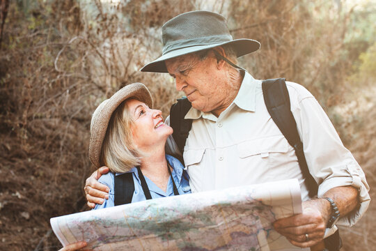 Lovely retired couple using a map to search for direction