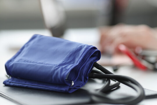 Blood pressure monitor lying on doctors table closeup