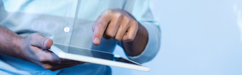 partial view of businessman pointing with finger at digital tablet with blank screen, banner