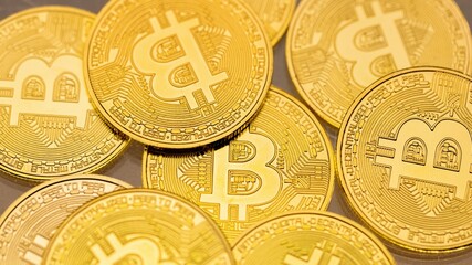 Physical shiny bitcoin agains dark background