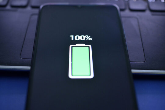 Close-up view of smartphone charging , battery level at full capacity - Powered by Adobe