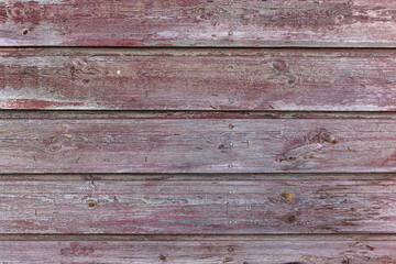 Painted wood background. High resolution image of weathered wood planks with red purple paint