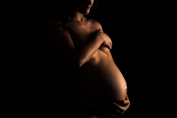 Pregnant girl in the dark, low key