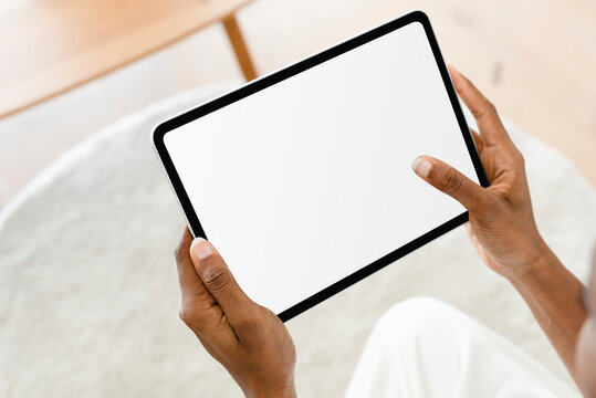 Hand holding digital tablet with blank white screen