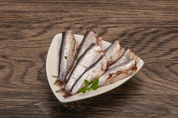 Anchovies in the bowl served basil leaves