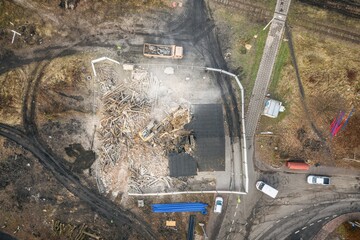 Yellow excavator destroys building. Heavy duty machine is demolishing a brick building. Demolition...
