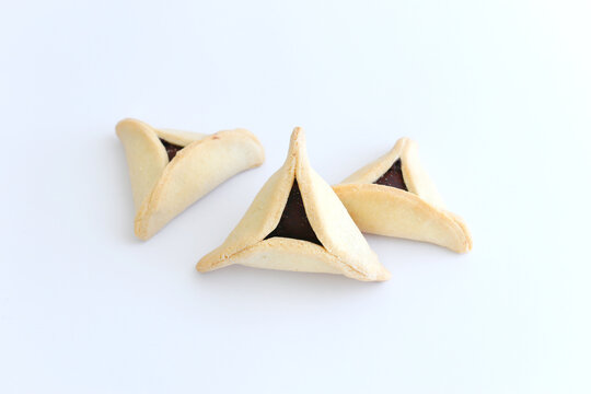 Purim celebration concept (jewish carnival holiday). Traditional cookie isolated on white