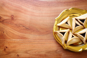 Purim celebration concept (jewish carnival holiday). Hamantaschen cookies over wooden table