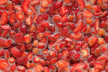 strawberry slices in juice jam background