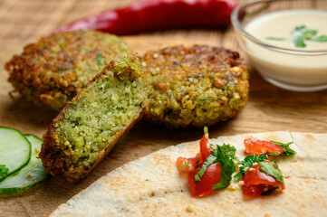 Homemade falafel served with pita bread, tomatoes, cucumber, lettuce, grilled aubergine salad and tahini sauce