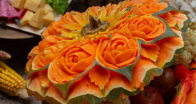 beautifully carved flowers on a pumpkin. art of carving