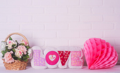 pillow in the form of the word love on a white background . concept of romance,
 Valentine's Day, Mothers Womans Day