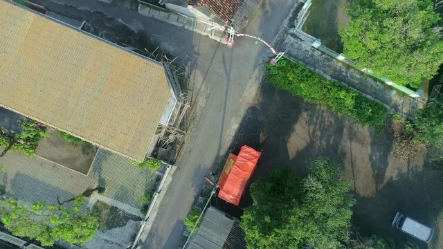 Top down view aerial footage of quiet intersection small road in neighbourhood Yogyakarta city, Indonesia during covid19 pandemic