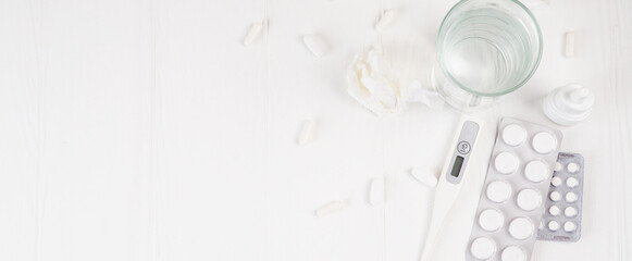 Banner Pills in plastic package. Concept of healthcare and medicine. Coronavirus 2019-nCoV, thermometer, runny nose, treatment of the disease