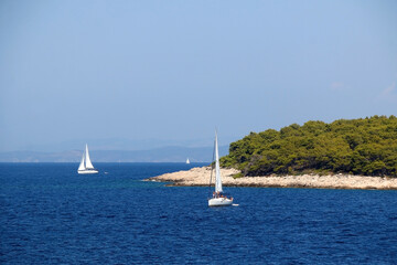 Sailing boat near island in Croatia. Beautiful Mediterranean landscape.