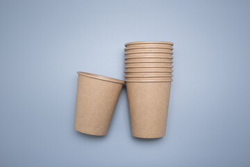 Wooden and cardboard disposable tableware on a gray background. Environmentally friendly products.