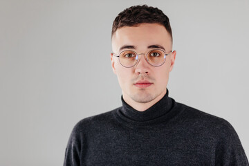 Young man with glasses smiling isolated on white background.