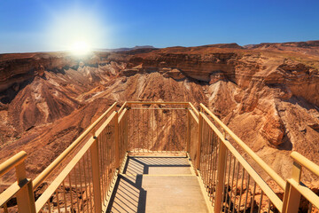 Masada fortress observation deck on great rock top against sun shining in Judaean Desert. Herod the...