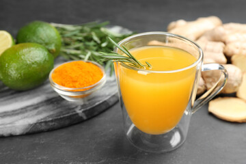 Immunity boosting drink and ingredients on dark table, closeup