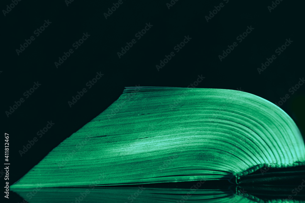 Fototapete Close up Beautiful book pages in the multi color light on a night. Background pattern for design. Macro photography view.