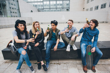 Group of friends multiethnic toasting drinking beer