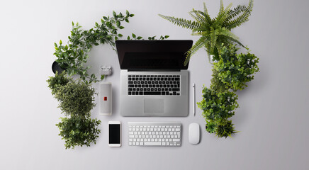 Fototapeta premium Flat lay top view office desk working space with laptop and supplies on gray background.
