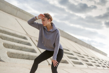 Portrait tired sporty woman outdoors