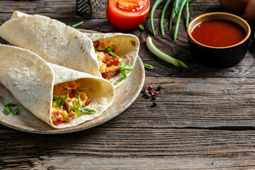 Breakfast quesadilla with fried eggs, bacon, cheese, Mexican food cuisine traditional dish. Food recipe background. space for text. top view