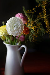 White vase of colorful flowers
