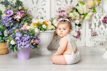 Obraz na płótnie Canvas baby with angel wings among flowers, valentine's day concept,