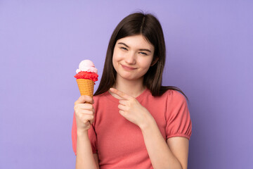 Young Ukrainian teenager girl holding a cornet ice cream over isolated purple background