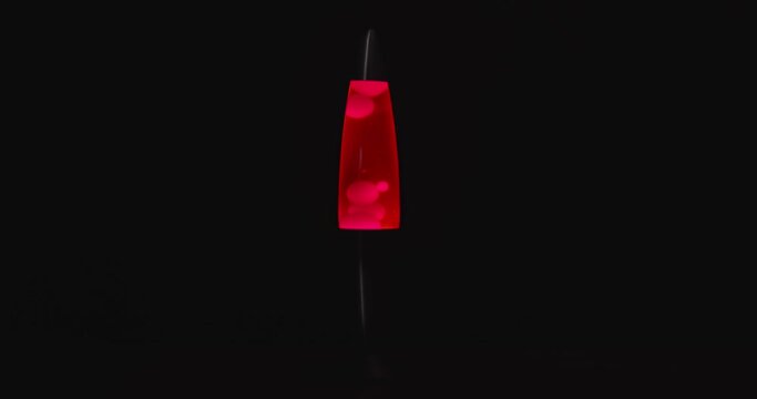 Red lava lamp aginast dark isolated background