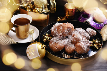 homemade doughnuts sprinkled with icing sugar called racuchy and coffee for carnival party