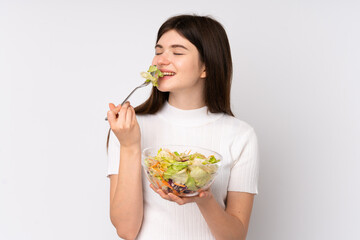 Young Ukrainian teenager girl holding a salad over isolated white background