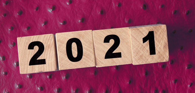 2021 new year on wooden cubes on red leather background. NY congradulation concept
