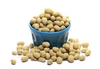 Sour cream and onion flavored peanuts pile in blue porcelain bowl isolated on white background