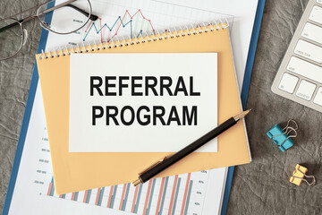 Referral program is written in a document on the office desk