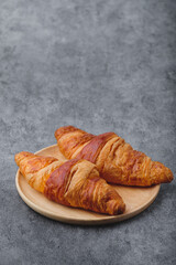 Fresh Baked Croissants on stone table.