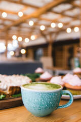 Matcha green tea latte in a cup. Top view. Copy space.