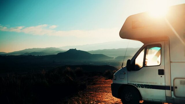 Time lapse of clouds moving over caravan camping on Tabernas desert, wild and barren landscape in Almeria, Spain. Movie location set for spaghetti western.