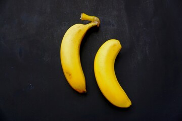 Two bananas isolated on black background.