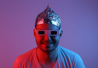 Crazy Bearded Man in a foil hat and 3D glasses in red blue neon light